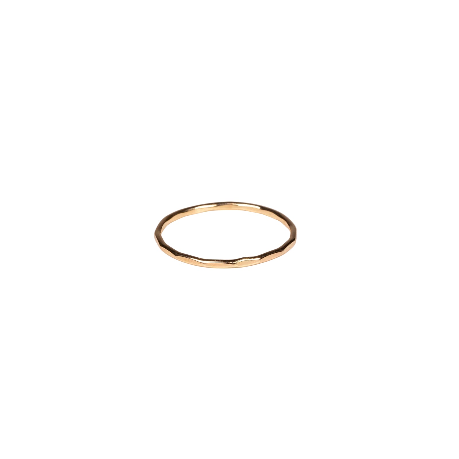 Gold ring on a light beige background