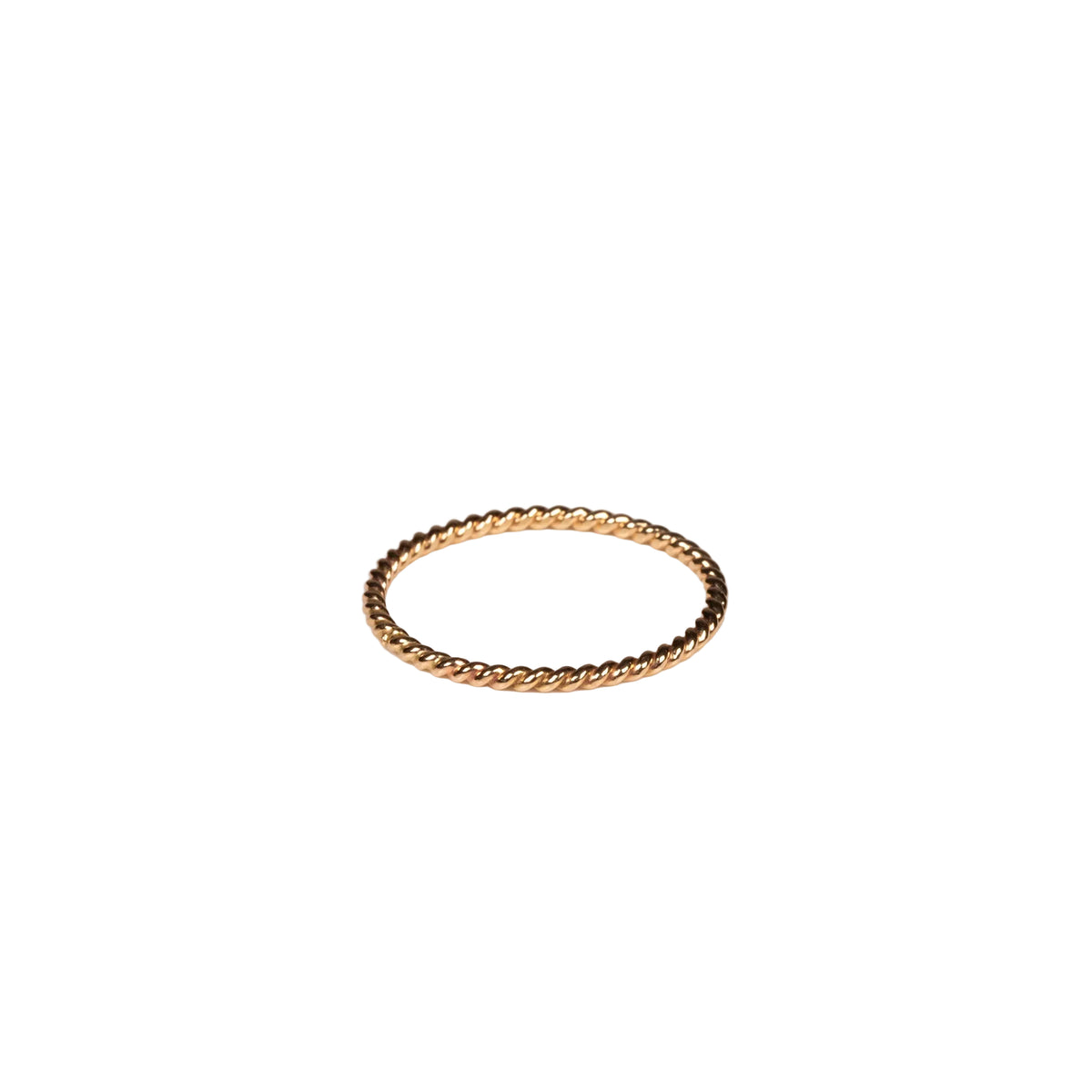 Gold ring on a light beige background