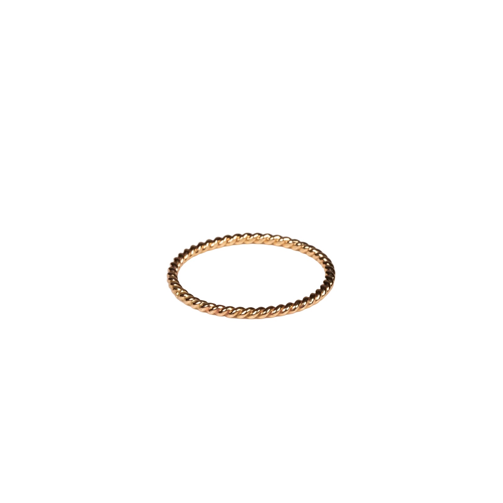 Gold ring on a light beige background