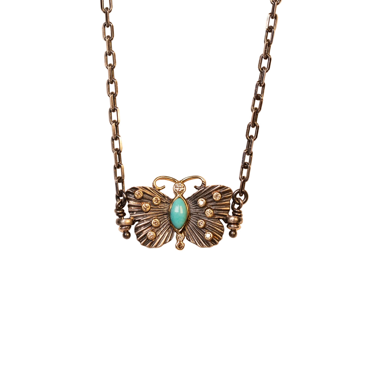 Butterfly-shaped necklace with turquoise stone on a beige background