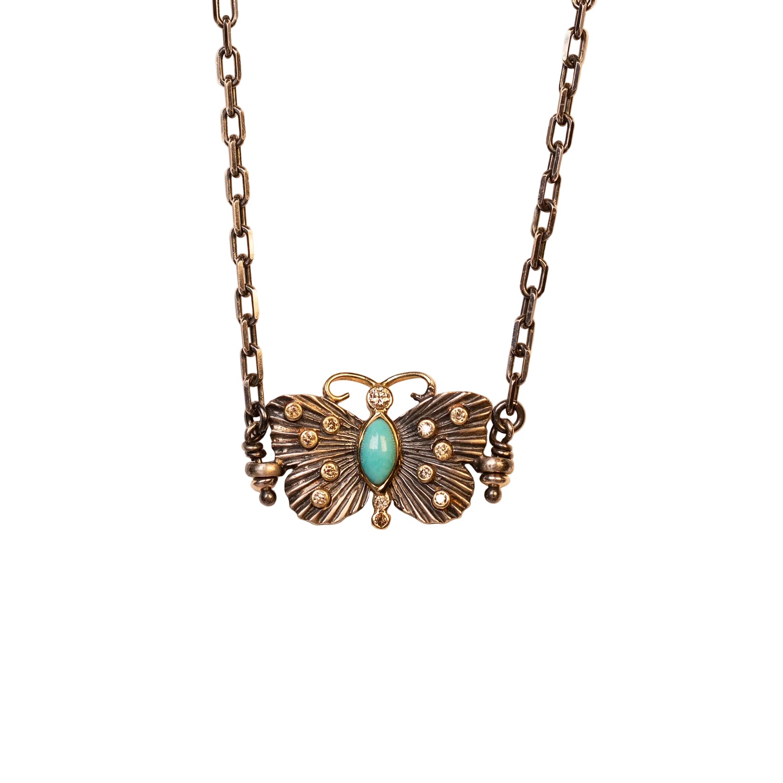 Butterfly-shaped necklace with turquoise stone on a beige background