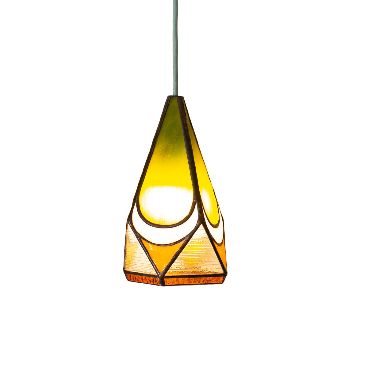 Stained glass yellow pendant light with a warm glow on a neutral wall background