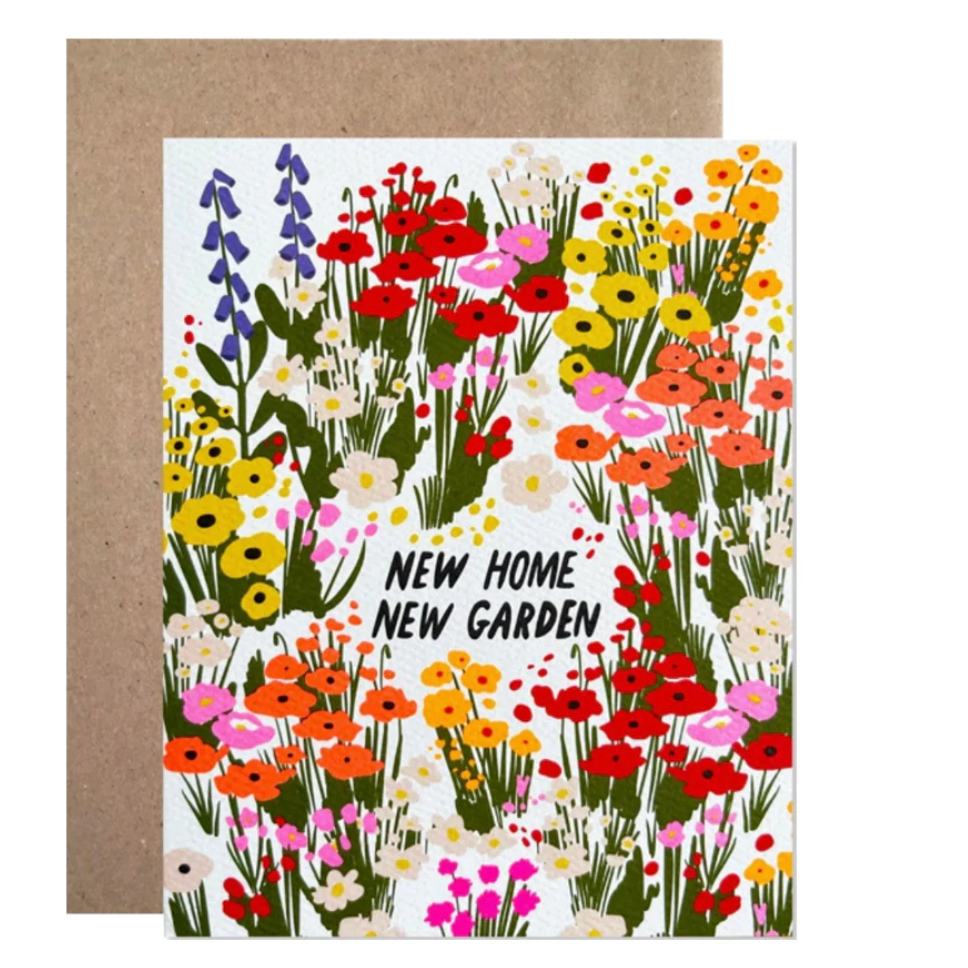 Greeting card with floral design and 'New Home New Garden' text, brown envelope.