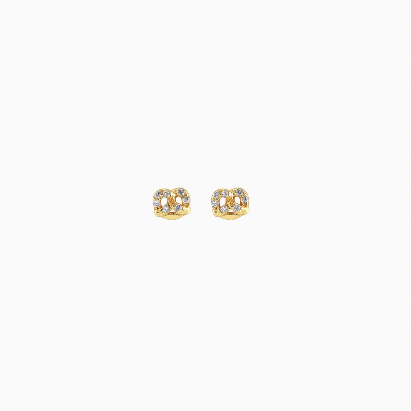 Gold pretzel earrings with small diamonds on a white background