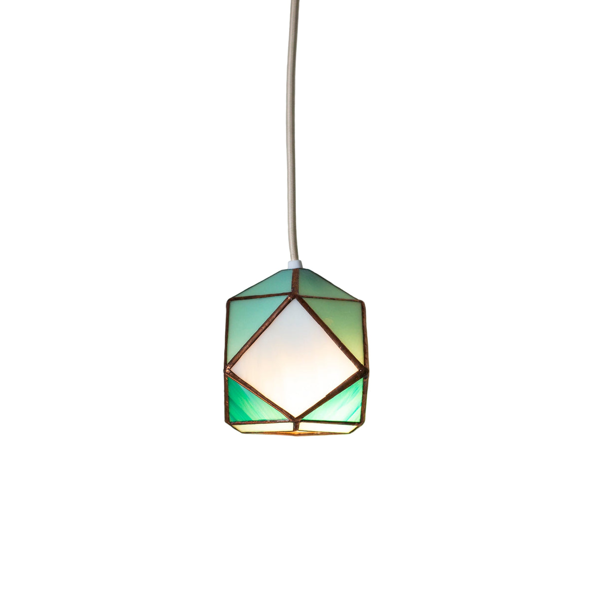 Geometric stained Glass pendant light with a green and white glass shade on a neutral wall.