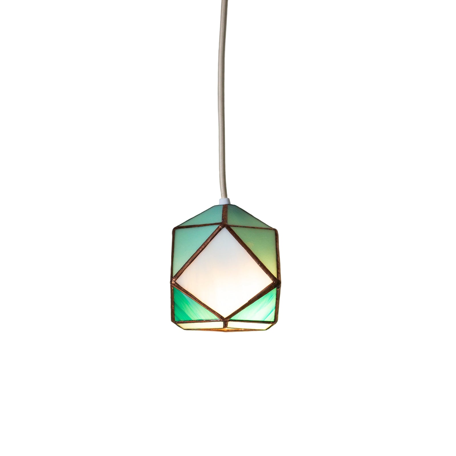 Geometric stained Glass pendant light with a green and white glass shade on a neutral wall.