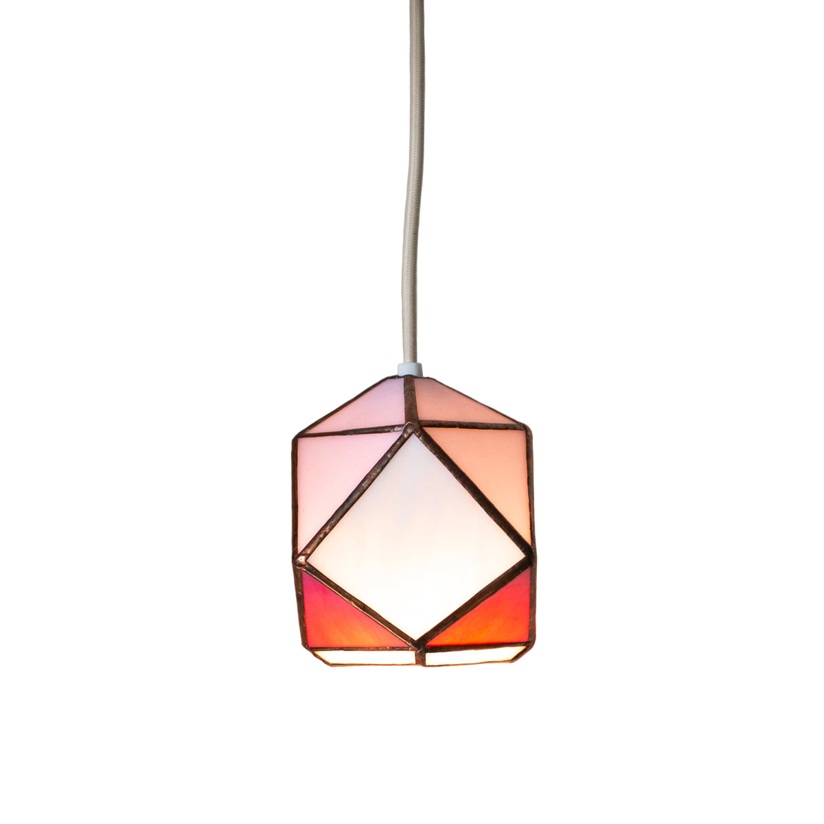 Geometric stained glass pendant light with stained glass design on a white wall.