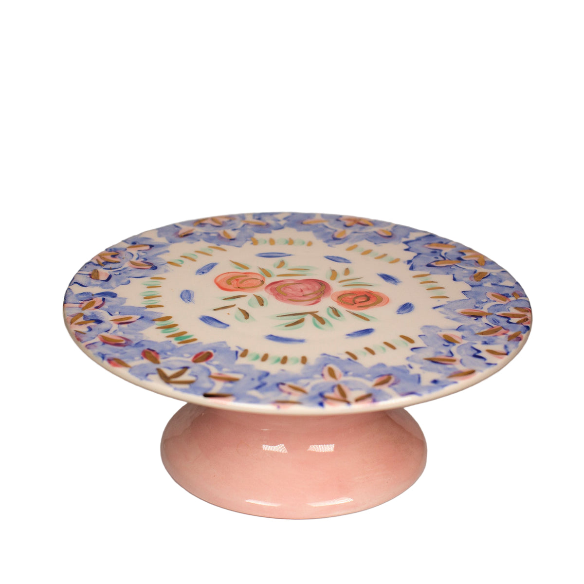 Ceramic cake stand with floral design on a plain background