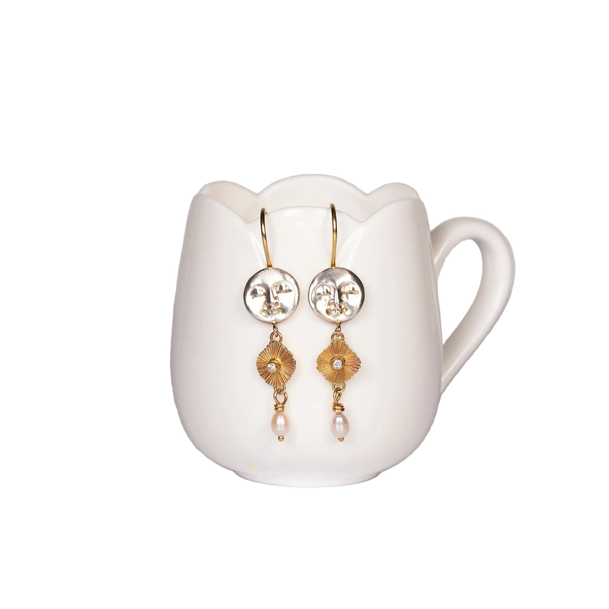 gold silver and pearl earrings with a moon face