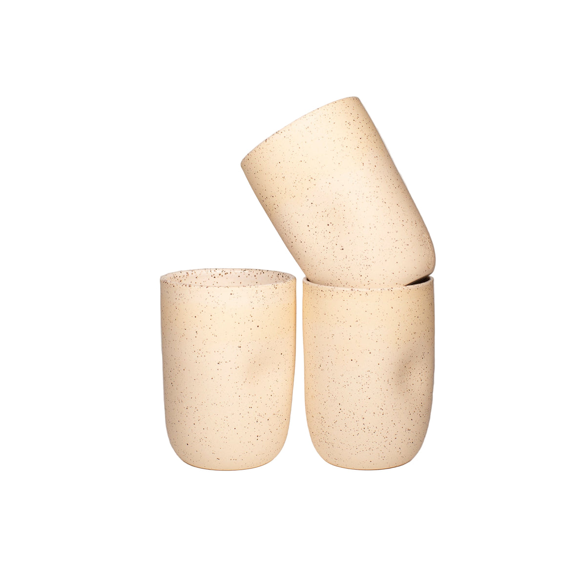 Buff speckled handthrown tumbler with a thumb dimple