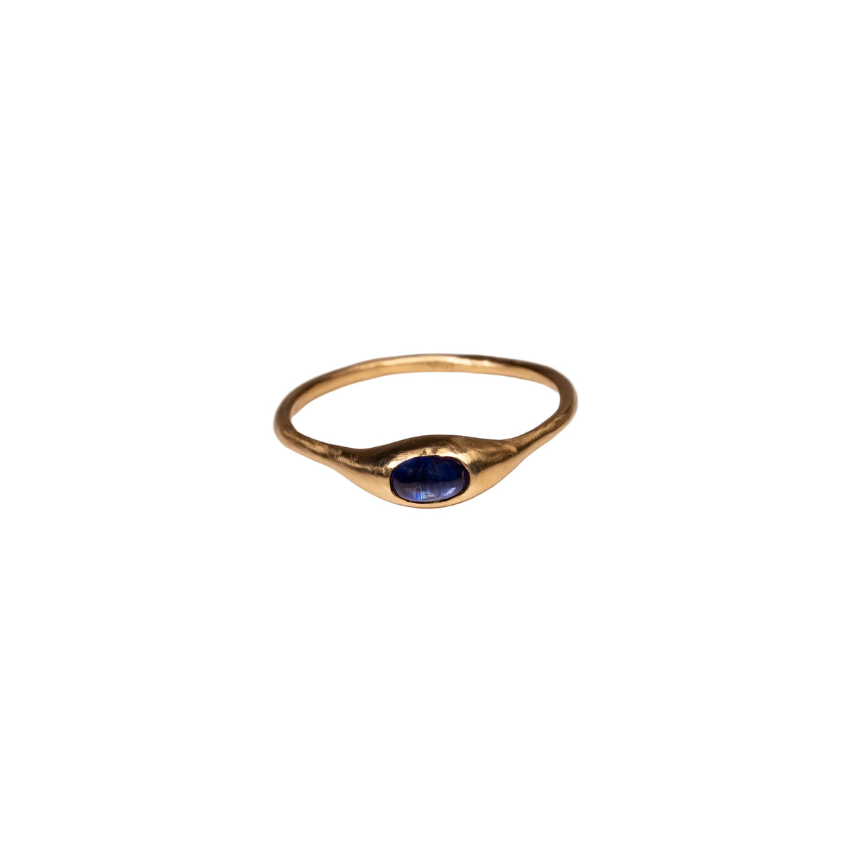 Gold ring with a blue kyanite gemstone on a white background