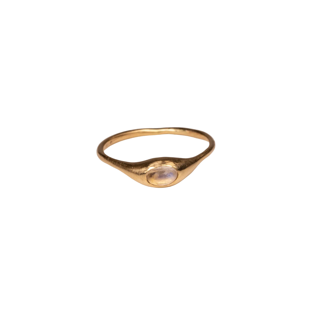 Gold ring with a central moonstone on a white background