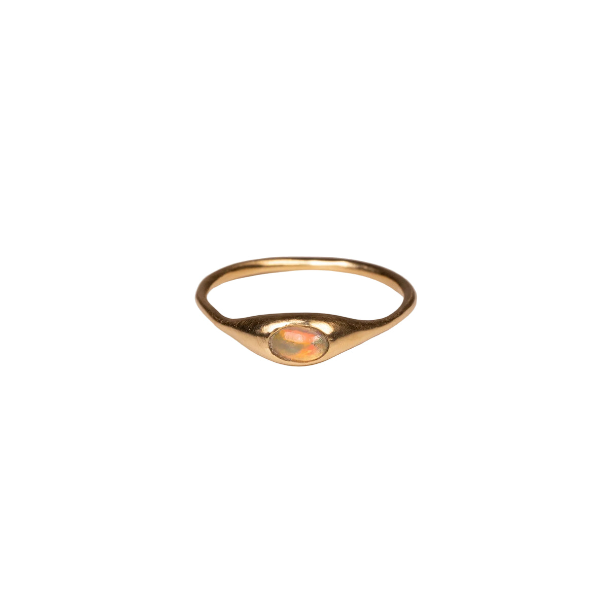 Gold ring with an opal on a white background