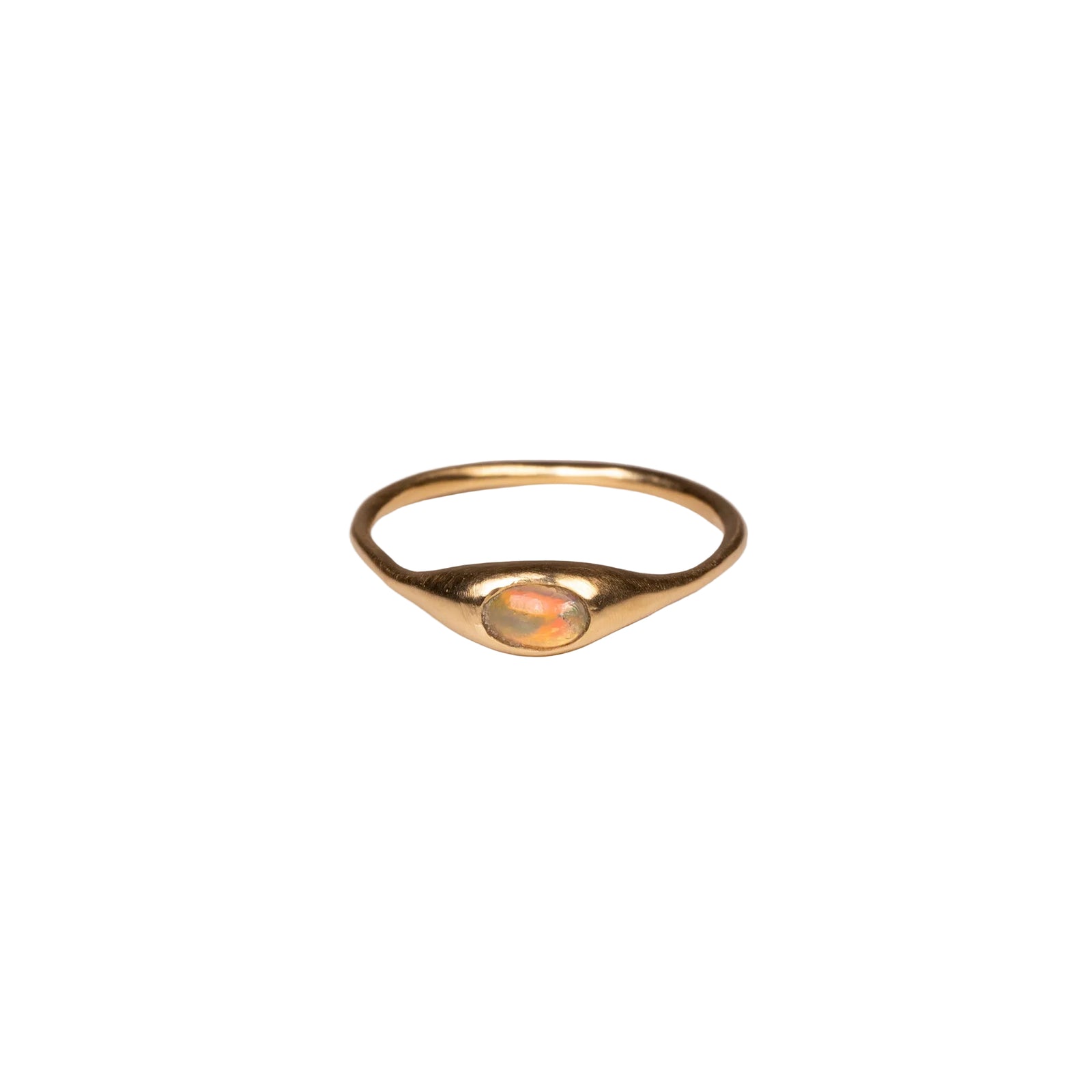Gold ring with an opal on a white background