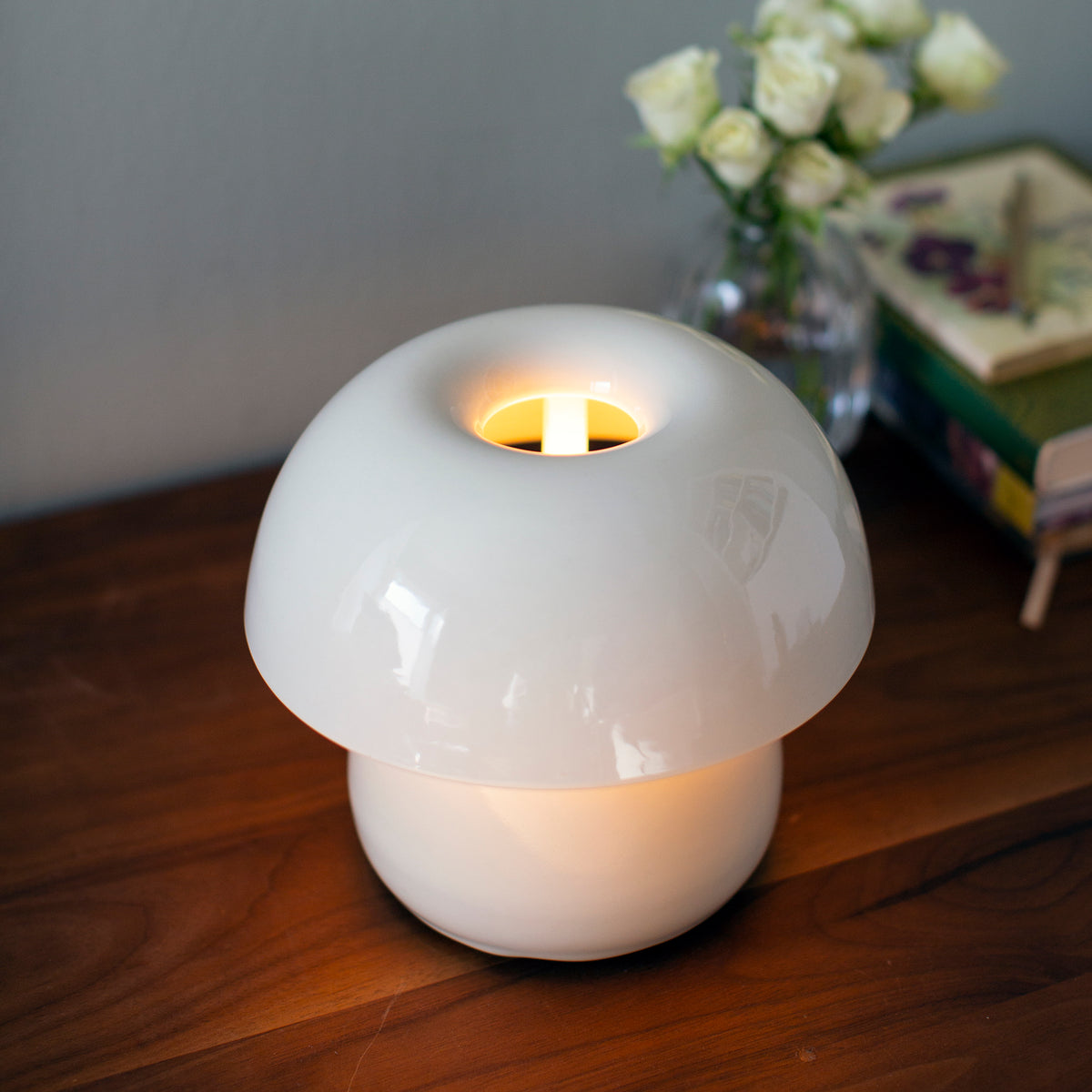 Mushroom-shaped night lamp on a wooden surface with a blurred background